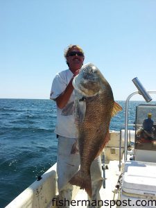 Eric Gowdy, of Wilmington, with a 50" black drum that struck a 3 oz. bucktail a two miles off Kure Beach.