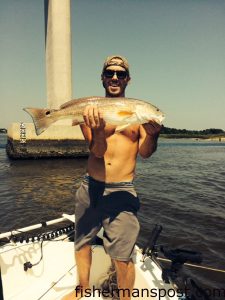 Adam Hartnett with a 25" red drum that bit a live menhaden at the Sunset Beach bridge.