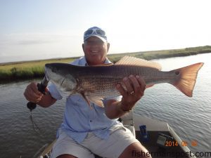 Curtis Pelt with a 26" puppy drum that bit a Strike King Ragetail Shrimp near Swan Quarter.