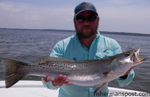 Raymond Brittain, of Holly Ridge, NC, with a big speckled trout that bit a topwater plug in the New River while he was fishing with Capt. Allen Jernigan of Breadman Ventures.