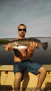 Bryan Milliken, of Rocky Point, NC, with a fat speckled trout that bit a live mud minnows on a jighead near Southport.