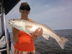 Sarah McAlister, of Monroe, NC, with a red drum she caught and released near Bald Head Island. It struck a live bait while she was fishing with Capt. Greer Hughes of Cool Runnings Charters.