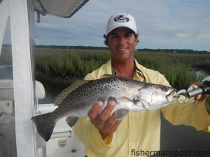 Capt. Patrick Kelly, of Capt. Smiley's Fishing Charters, with a 4 lb. speckled trout that bit a Gulp swimming mullet in Bonaparte Creek.