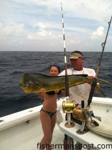 Caroline Smith and Nick Nichols, of Morehead City, with a dolphin that struck a skirted ballyhoo while they were trolling at the Big Rock with Capt. Casey Fiorini on the "Beagle."