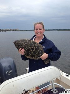 Mary Kate West with a 7 lb. flounder that she caught while ifshing with her husband.