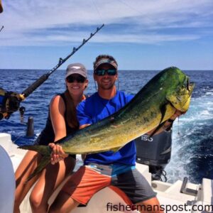 Marissa Schlenker, of Garner, NC, and Matthew Spivey with a dolphin that bit a ballyhoo under a blue/white Ilander near the Big Rock.