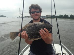 Brett Beane, of Asheboro, NC, with a 21" flounder that struck a Carolina-rigged finger mullet beneath the Ocean Isle Beach bridge.