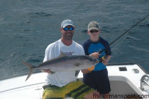 Mate Russell Long and William Gaines with an amberjack that William hooked on a sight-cast bucktail jig while they were fishing some bottom structure off Oregon Inlet on the "Poacher."