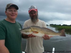 Nathan Henderson and "Dixie" Dave Collins with Dave's first red drum, a 26.75" fish that bit a live finger mullet near Masonboro Inlet while they were fishing with Capt. Jamie Rushing of Seagate Charters.