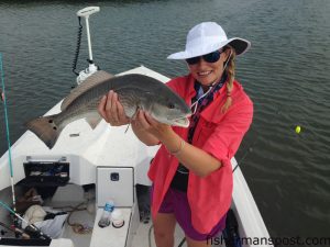 Heather Harmsen, of Cary, with a 23" red drum she hooked on a topwater plug in the ICW near Wrightsville Beach.