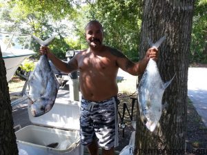 Roger Olvera, of Oak Island, with a pair of African pompano that he hooked on cigar minnows near Frying Pan Tower.