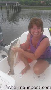 Julie Holden with her first red drum, a 27" fish that bit a live minnow near Holden Beach.