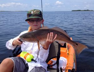 Gabe Aldous holding a 25" puppy drum he hooked while kayak fishing near Oregon Inlet. Photo courtesy of TW's Tackle.