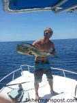 Capt. Corbett Johnson, of Reelax Fishing Charters, with a bull dolphin he hooked on a green/pink-skirted squid strip while trolling off Beaufort Inlet near the NW Places.