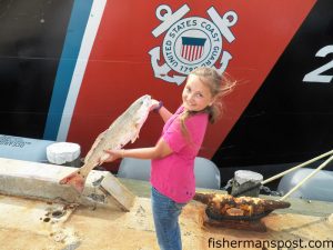 Bethany Arnold with a red drum she hooked on a Gulp bait while fishing near Ft. Macon with her father Wyndal.