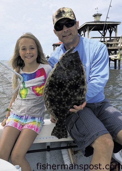 Dessie and Madison Howard with Dessie's first flounder, a 4 lb. fish that struck a live finger mullet at the Southport waterfront while they were fishing with Capt. Alan Beasley on the "Reel Rocker."