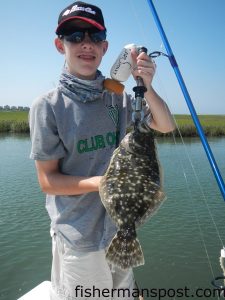 John Mannix, of Marietta, OH, with a flounder that struck a live mud minnow while he was fishing in Tubbs Inlet with Capt. Patrick Kelly of Capt. Smiley's Fishing Charters.