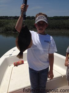 Thomas Suggs (age 13) with a 17" flounder that bit a mud minnow near Murrells Inlet, SC.