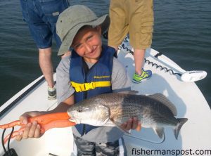 Cashton Reynolds, of Indianapolis, IN, with his first red drum, hooked near Topsail Beach while he was fishing with Capt. Jason Dail of Silverspoon Charters.