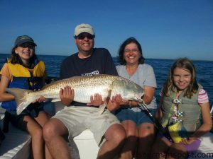 Ana, David, Sara, and Daniela Topsana with a citation red drum they caught and released at some nearshore structure near Wrightsville Beach while fishing with Capt. Jamie Rushing of Seagate Charters.