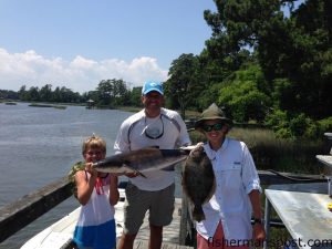 Harrison, Reed, and Michael Branham, of Charlotte, with a cobia and a flounder they hooked off Wrightsville Beach while fishing with Steve Campbell.