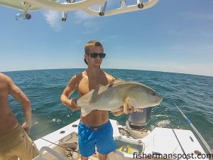 Colin Jones with a large red drum that bit a live mud minnow near the McGlamery Reef off Oak Island while he was fishing with Austin Jones.