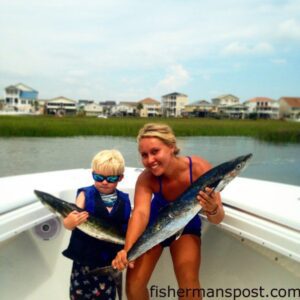 Brayden McMullan and Katelyn Kincer, of the Ocean Isle Fishing Center, with a pair of king mackerel they hooked while slow-trolling live menhaden at the Shark Hole.