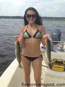 Dreama Tapia, of Wilmington, with a pair of speckled trout that bit live finger mullet in a Masonboro Island creek.