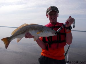 Ezekiel Wiggins, of High Point, NC, with an overslot red drum that struck a gold spoon while he was fishing the New River with Capt. Allen Jernigan of Breadman Ventures.