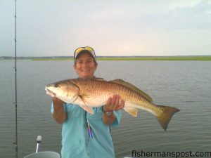 Beth Ward, of Wilmington, with a 31" red drum she caught and released behind Lea Island while fishing aboard the "BeDeFish."