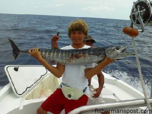 James Lutz (age 14), of Oak Island, with his first wahoo, hooked near the Blackjack Hole on a skirted ballyhoo while he was fishing with Steve Peloza.