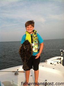 Brayden Wollard with a 22" flounder that struck a white Gulp shrimp near Raccoon Island in the Pamlico Sound.