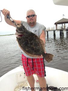 Austin Wood, of Wilmington, with an 8.8 lb., 27" flounder that bit a live finger mullet near Snows Cut.