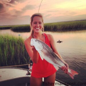 Brittany English, of Wilmington, with a 23" red drum that attacked a live finger mullet just north of Wrightsville Beach while she was fishing with Robert Johnston.