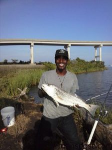 Darryl Davis II, of Jacksonville, NC, with a 32" red drum he caught and released near Sneads Ferry after it struck a live finger mullet.