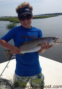 Hunter Wood (age 10), of Emerald Isle, with a 5.5 lb., 25" speckled trout that struck a live finger mullet in a Bogue Sound marsh.