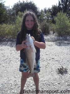 Aloni Hargett with her first red drum, a 26.5" fish she hooked near Swansboro on a live finger mullet.