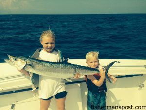 Caroline and Brayden McMullan with a 25 lb. king mackerel that struck a live bait on the downrigger while they were fishing with their dad on the "Team OIFC" out of the Ocean Isle Fishing Center.