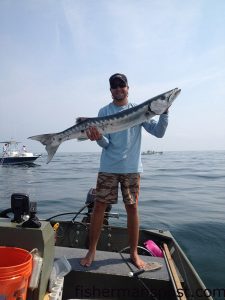 Jared Beard, of Wilmington, with a 54" barracuda he caught and released at the Liberty Ship after it struck a live grunt on a king rig. Bucktail