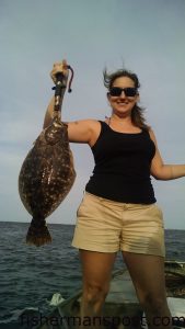 Audrey Grisso with a fat flounder that fell for a live finger mullet near Bald Head Island while she was fishing with her husband Jay and son Ryan.