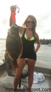 Kaitlyn Favolise, of Wilmington, NC, with a 28" flounder that struck a Carolina-rigged finger mullet in Murrellls Inlet while she was fishing with Kyle Peters.