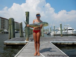 Ada Everette (age 12) with a dolphin that struck a ballyhoo near the NW Places while she was trolling off Beaufort Inlet.