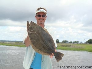 Mark Vickers with a 7.3 lb., 26" flounder that attacked a live finger mullet near Carolina Beach.