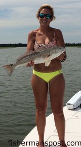 Anna Hurst with a red drum that she caught while fishing a Swansboro-area marsh with her father and son.