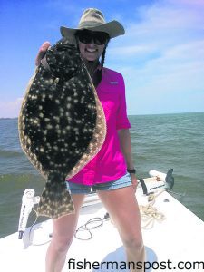 Lindsey Woods, of Stillwater, OK, with a flounder that inhaled a live bait near Southport while she was fishing with Capt. Greer Hughes of Cool Runnings Charters.