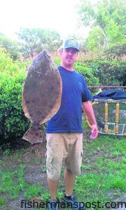 Ray Fowler, of Wilmington, with an 11 lb. flounder that struck a live mullet in Snows Cut.