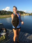 Samantha Suarez with a 22" flounder that bit a live finger mullet on a high falling tide at a Topsail-area dock.