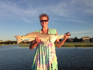 Natalie Godwin, of Beaufort, NC, with her first red drum, a 25" fish that struck a Gulp shrimp in a Topsail Island bay while she was fishing with her boyfriend Will Epperson.