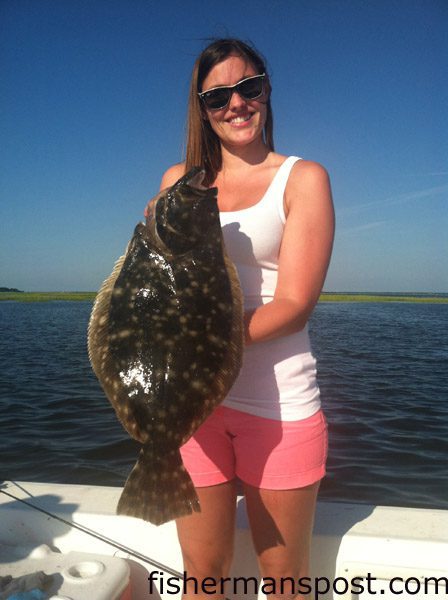 Katie Kuzma, of Leesburg, VA, with a 5.5 lb. flounder that bit a live finger mullet near a marsh grass point behind Emerald Isle. She was fishing with Capt. Rob Koraly of Sandbar Safari Charters.