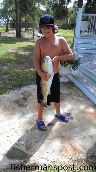 Tucker Holland (age 9) with a 27″ red drum he hooked in Bogue Sound while fishing with his grandfather.